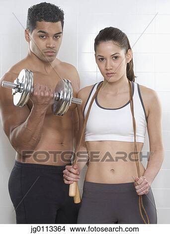 Picture - Portrait of a young couple exercising. Fotosearch