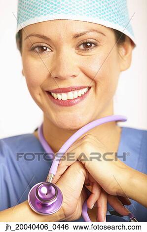 Portrait of a young female doctor in full scrubs View Large Photo Image Stock Photograph - Portrait of a young female doctor in full scrubs. Fotosearch