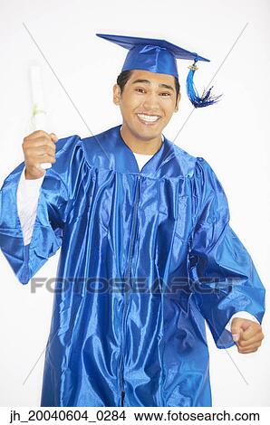 Portrait of a young male graduate holding a degree View Large Photo Image Picture - Portrait of a young male graduate holding a degree. Fotosearch