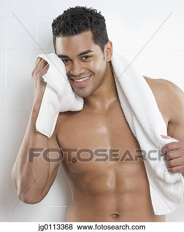 Portrait of a young man rubbing his face with a towel View Large Photo Image Stock Photo - Portrait of a young man rubbing his face with a towel. Fotosearch