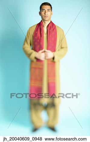 Portrait of a young man wearing a traditional outfit View Large Photo Image Stock Photo - Portrait of a young man wearing a traditional outfit. Fotosearch