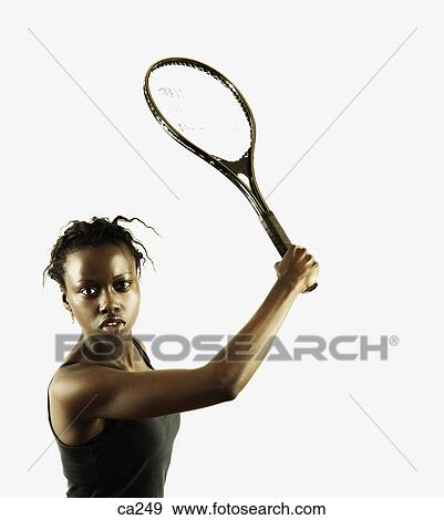 Stock Photo - Portrait of a young woman playing tennis. Fotosearch