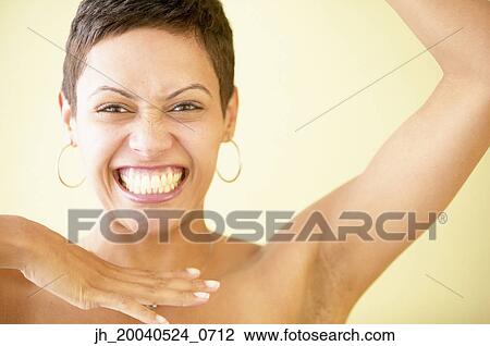 Stock Image - Portrait of a young woman smiling. Fotosearch