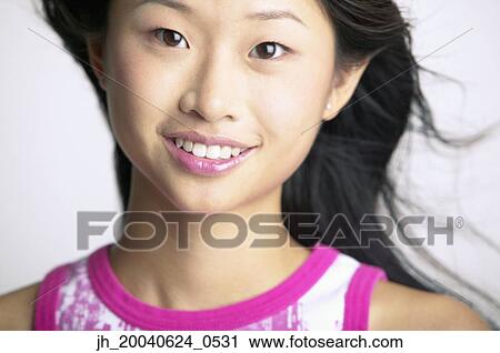 Portrait of a young woman smiling View Large Photo Image Stock Image - Portrait of a young woman smiling. Fotosearch