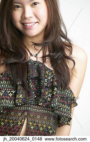 Portrait of a young woman smiling View Large Photo Image Stock Photo - Portrait of a young woman smiling. Fotosearch