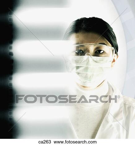Portrait of a young woman wearing a surgical mask View Large Photo Image Stock Image - Portrait of a young woman wearing a surgical mask. Fotosearch