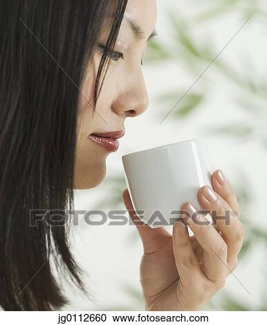 Side profile of a mid adult woman holding a cup View Large Photo Image Stock Image - Side profile of a mid adult woman holding a cup. Fotosearch