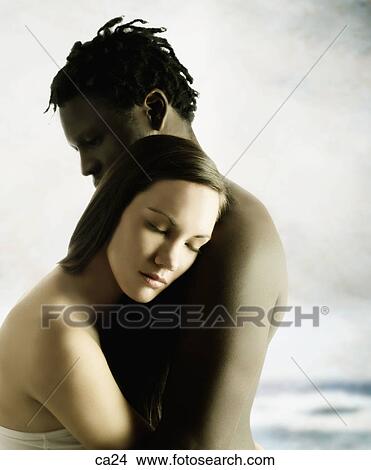 Side profile of a young couple holding each other View Large Photo Image Picture - Side profile of a young couple holding each other. Fotosearch