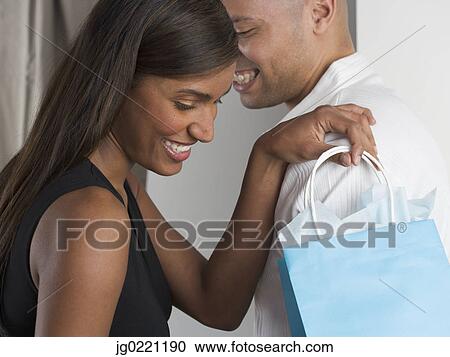 Side profile of a young couple smiling View Large Photo Image Stock Image - Side profile of a young couple smiling. Fotosearch