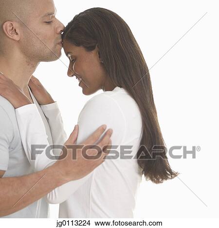Side profile of a young man kissing a young woman View Large Photo Image Picture - Side profile of a young man kissing a young woman. Fotosearch
