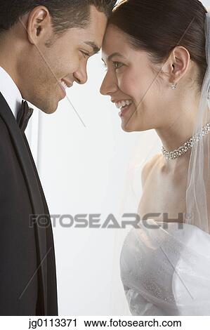 Side profile of a young newly wedded couple View Large Photo Image Stock Image - Side profile of a young newly wedded couple. Fotosearch