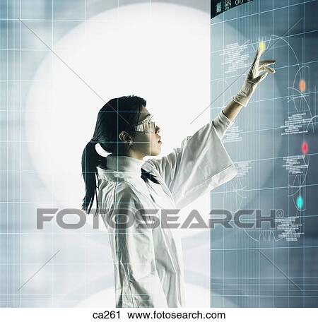 Stock Image - Side profile of a young woman using a visual screen. Fotosearch
