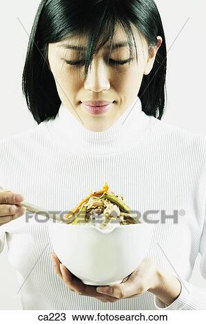 Young woman holding a bowl View Large Photo Image Stock Image - Young woman holding a bowl. Fotosearch