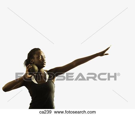 Stock Photo - Young woman holding a shot put ball. Fotosearch