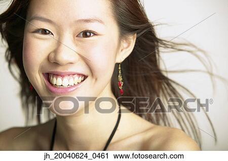 Young woman smiling looking at camera View Large Photo Image Stock Image - Young woman smiling looking at camera. Fotosearch