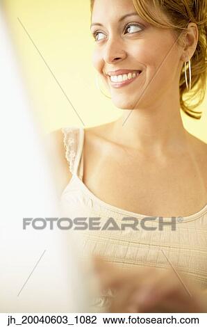 Stock Image - Young woman smiling. Fotosearch