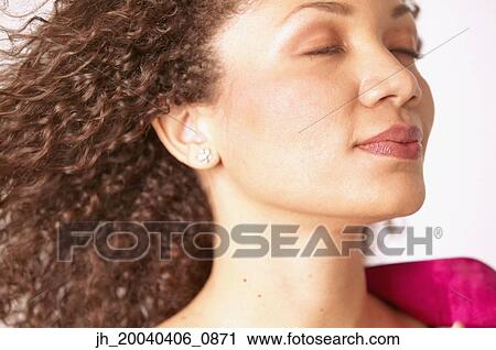 Young woman with her eyes closed View Large Photo Image Stock Image - Young woman with her eyes closed. Fotosearch