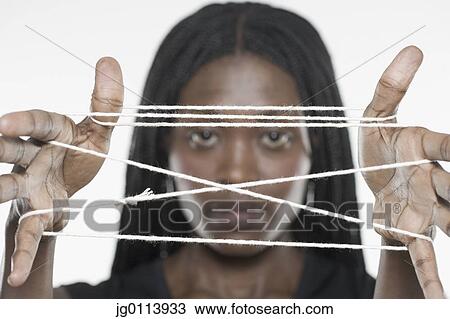 Close-up of a mid adult woman holding a string View Large Photo Image Stock Image - Close-up of a mid adult woman holding a string. Fotosearch