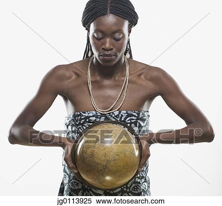 Close-up of a mid adult woman holding a globe View Large Photo Image Stock Photography - Close-up of a mid adult woman holding a globe. Fotosearch