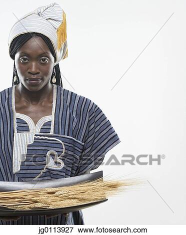 Stock Photo - Close-up of a mid adult woman holding husk. Fotosearch