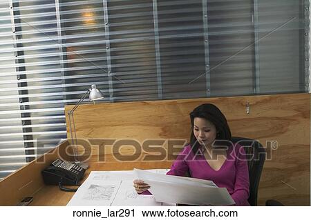 High angle view of a businesswoman looking at blueprints in an office View Large Photo Image Stock Image - High angle view of a businesswoman looking at blueprints in an office. Fotosearch