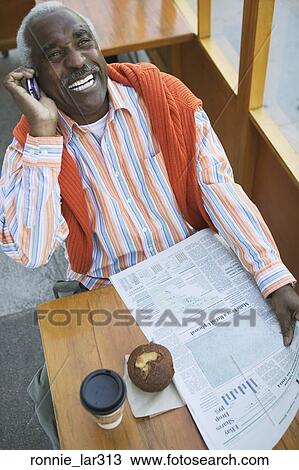 High angle view of a mature man talking on a mobile phone View Large Photo Image Stock Image - High angle view of a mature man talking on a mobile phone. Fotosearch