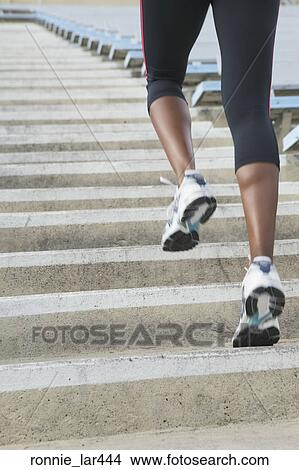 Low section view of an athlete practicing on the running track View Large Photo Image Picture - Low section view of an athlete practicing on the running track. Fotosearch