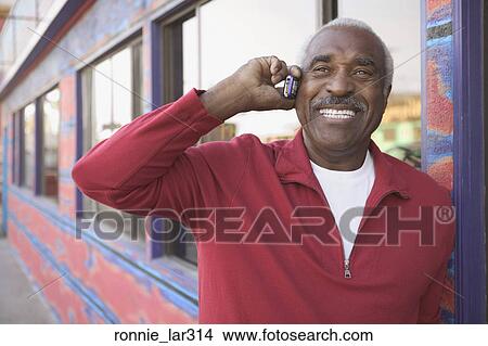 Mature man talking on a mobile phone View Large Photo Image Picture - Mature man talking on a mobile phone. Fotosearch