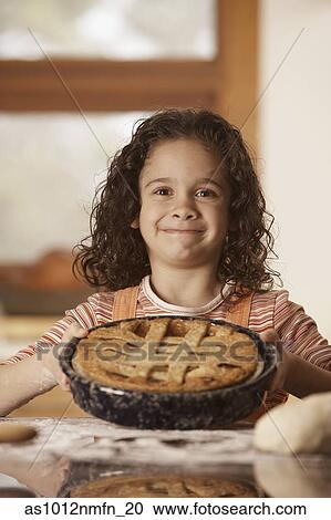 Portrait of a girl holding a pie View Large Photo Image Stock Image - Portrait of a girl holding a pie. Fotosearch
