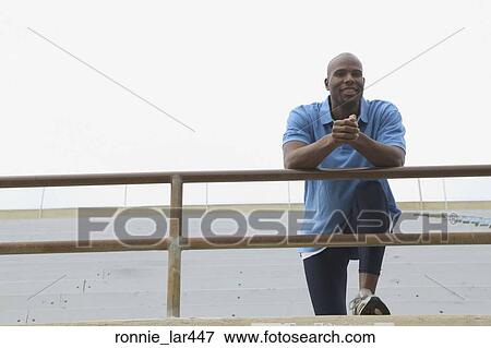 Portrait of a mid adult man leaning over a railing View Large Photo Image Stock Photo - Portrait of a mid adult man leaning over a railing. Fotosearch