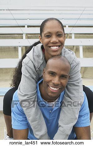 Portrait of a mid adult woman embracing a mid adult man View Large Photo Image Stock Image - Portrait of a mid adult woman embracing a mid adult man. Fotosearch