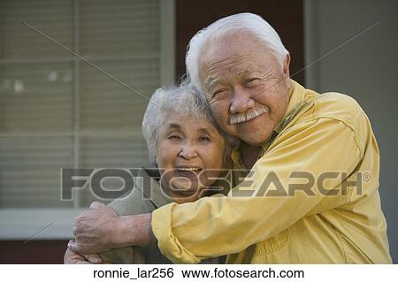 Stock Photograph - Portrait of a senior couple embracing each other. Fotosearch