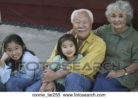 Portrait of a senior couple sitting with their granddaughters View Large Photo Image Stock Photography - Portrait of a senior couple sitting with their granddaughters. Fotosearch