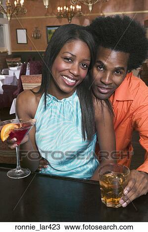 Portrait of a young couple smiling in a nightclub View Large Photo Image Stock Image - Portrait of a young couple smiling in a nightclub. Fotosearch