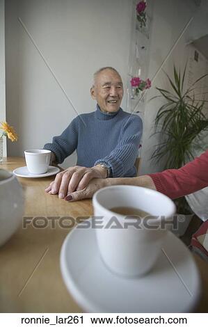 Senior man holding hands of a senior woman View Large Photo Image Stock Image - Senior man holding hands of a senior woman. Fotosearch