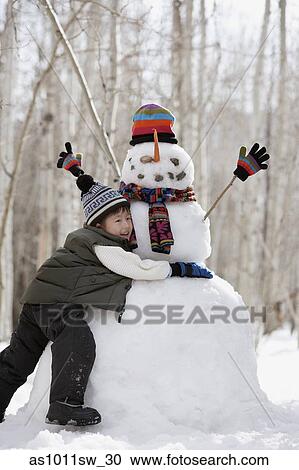 Side profile of a boy hugging a snowman View Large Photo Image Stock Image - Side profile of a boy hugging a snowman. Fotosearch