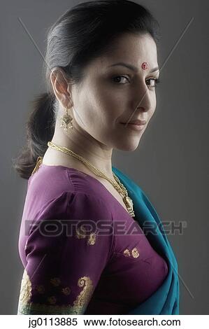 Side profile of a mid adult woman smiling View Large Photo Image Stock Photography - Side profile of a mid adult woman smiling. Fotosearch