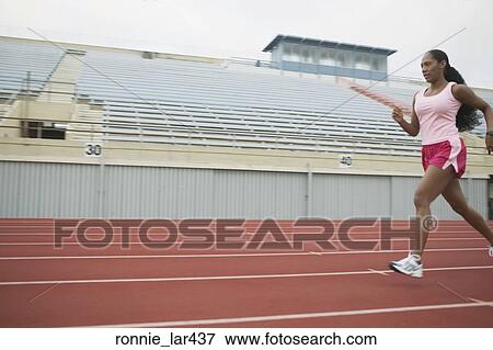 Side profile of an athlete running on the running track View Large Photo Image Stock Photo - Side profile of an athlete running on the running track. Fotosearch