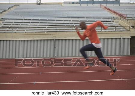 Side profile of an athlete running on the running track View Large Photo Image Stock Photo - Side profile of an athlete running on the running track. Fotosearch