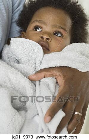 Baby girl wrapped up in towel View Large Photo Image Stock Image - Baby girl wrapped up in towel. Fotosearch