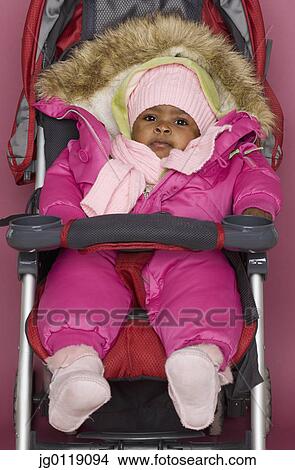Picture - Baby girl wrapped up in winter clothes. Fotosearch