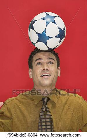 Businessman headering a soccer ball View Large Photo Image Picture - Businessman headering a soccer ball. Fotosearch