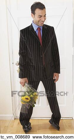 Businessman holding a bunch of flowers View Large Photo Image Stock Photo - Businessman holding a bunch of flowers. Fotosearch