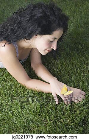 Butterfly resting on young woman's hand View Large Photo Image Stock Photo - Butterfly resting on young woman's hand. Fotosearch
