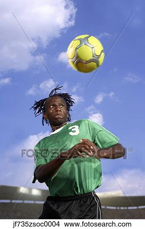 Picture - Male soccer player headering the ball. Fotosearch