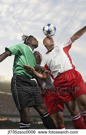 Male soccer player headering the ball before others View Large Photo Image Stock Photograph - Male soccer player headering the ball before others. Fotosearch