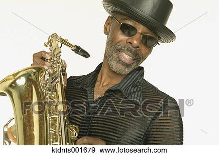 Middle aged man playing the saxophone View Large Photo Image Stock Photo - Middle aged man playing the saxophone. Fotosearch