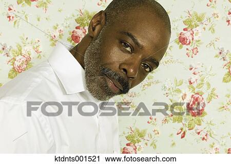 Middle aged man posing for the camera View Large Photo Image Stock Image - Middle aged man posing for the camera. Fotosearch