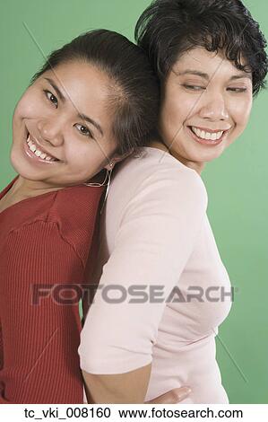 Stock Image - Mother and daughter smiling for the camera. Fotosearch