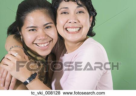 Stock Photo - Mother and daughter smiling for the camera. Fotosearch